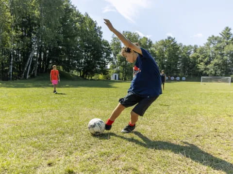 a man kicking a football ball