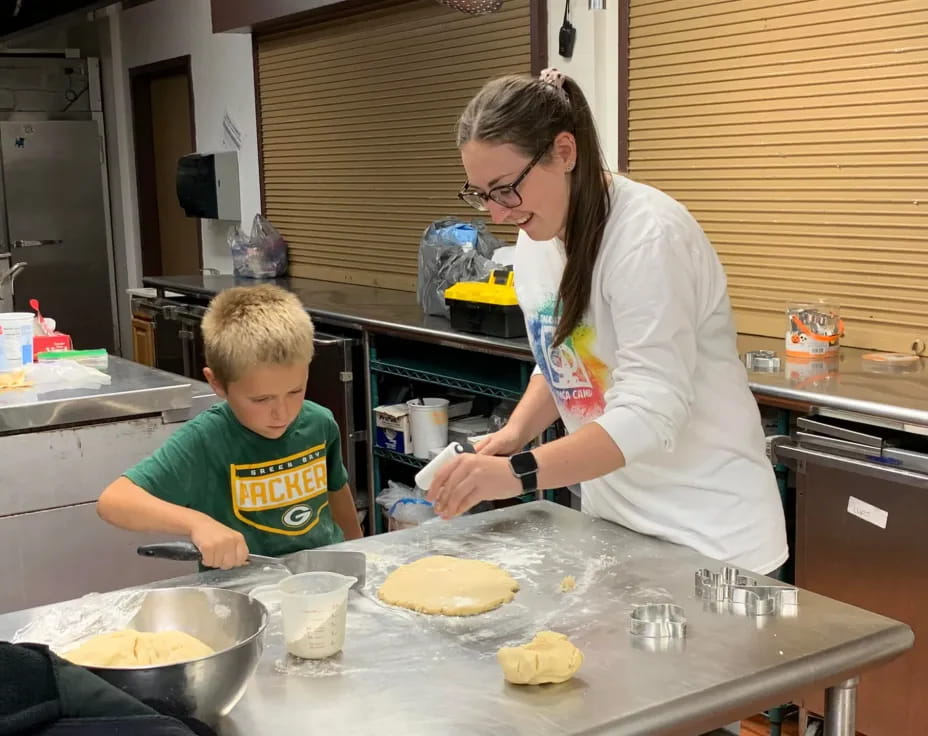a person and a boy preparing food