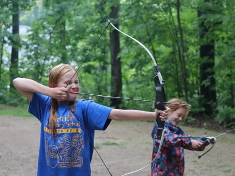 a couple of girls shooting bows