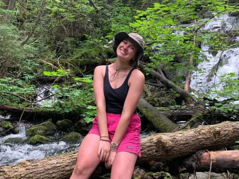a woman standing on a log