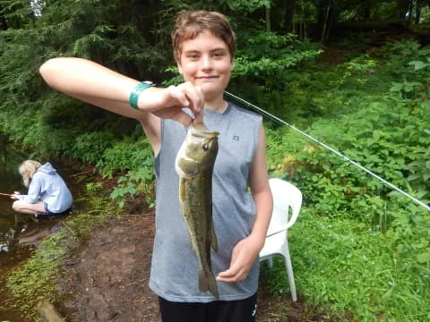 a boy holding a fish