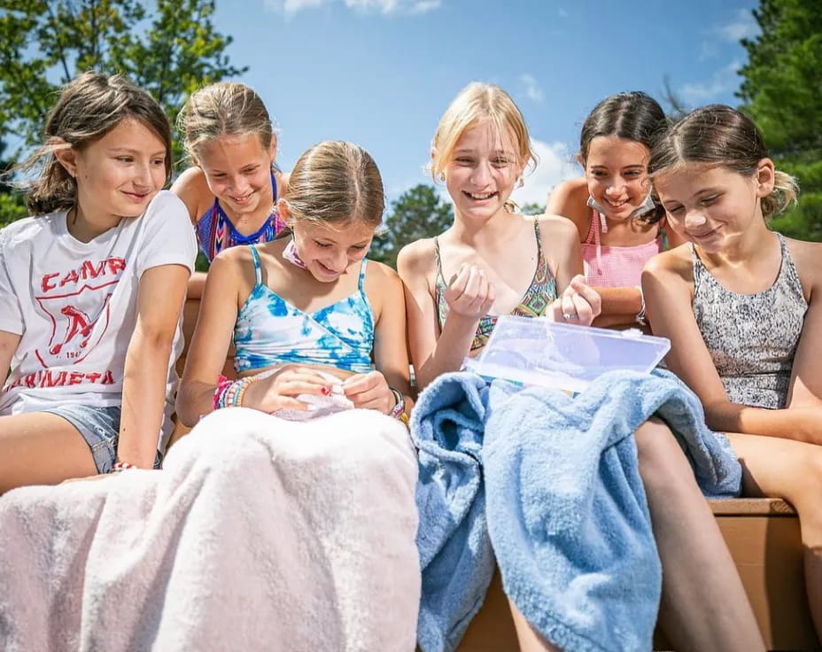 a group of girls sitting on a bench