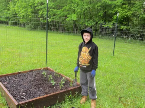 a boy holding a shovel