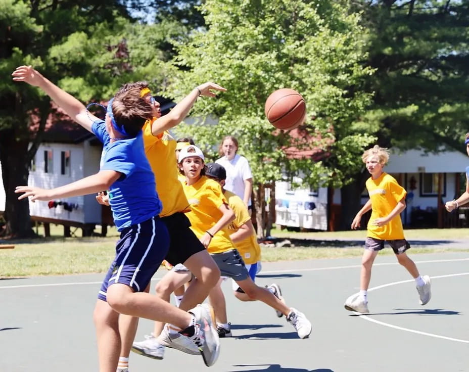 a group of people playing basketball