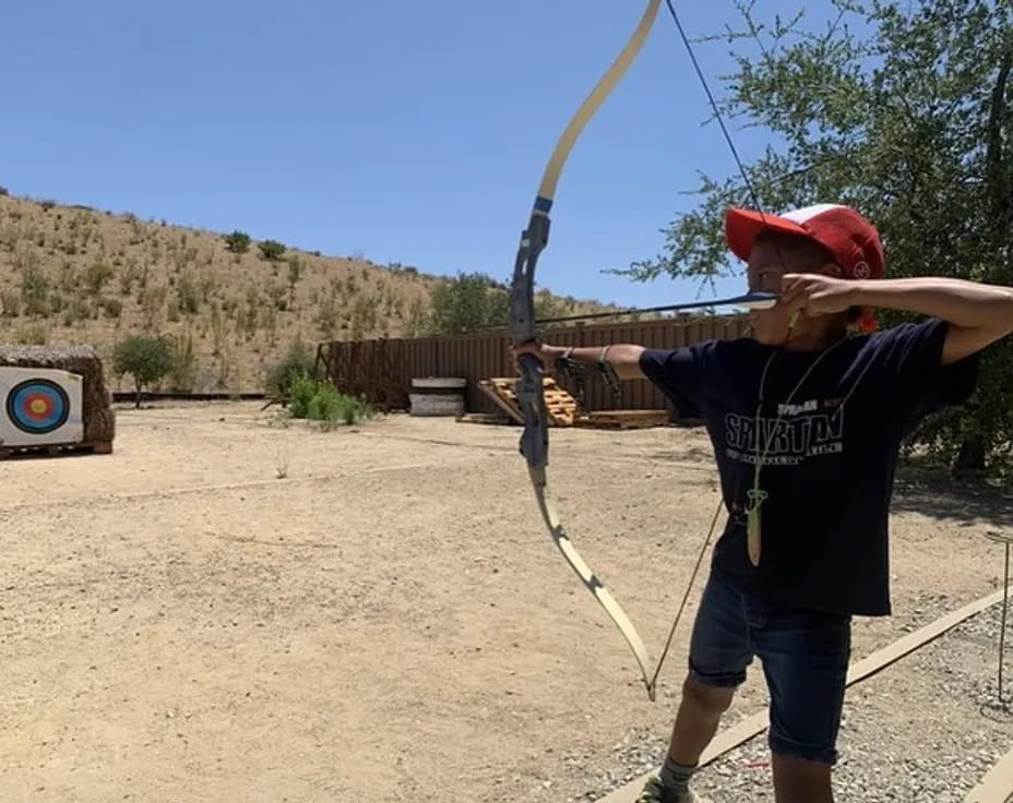 a person shooting a bow and arrow
