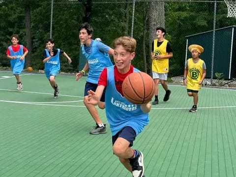 a group of kids playing basketball
