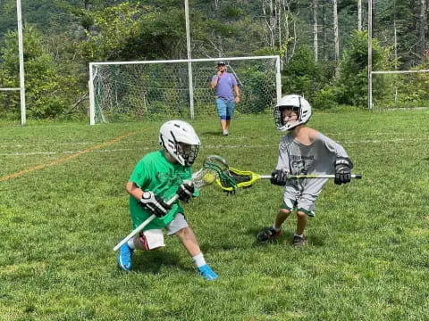 kids playing lacrosse on a field