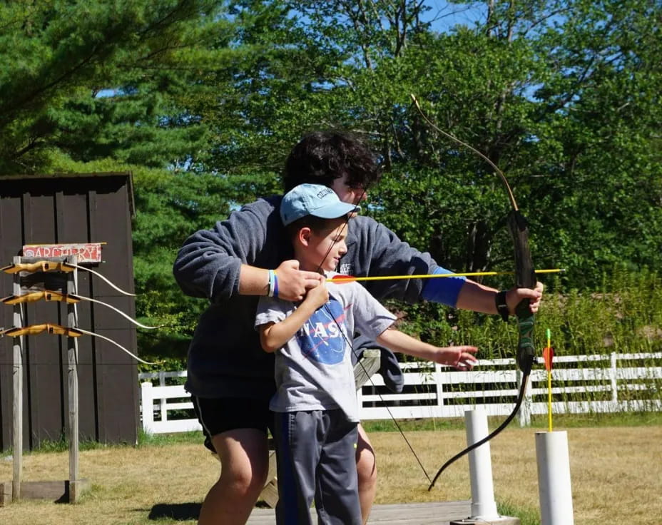 a man holding a boy on a swing