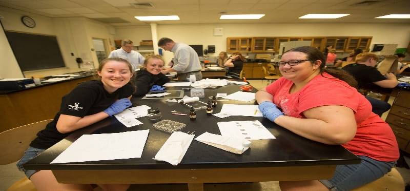 a group of people sitting at a table with paper on it