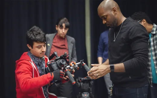 a man and a woman looking at a camera