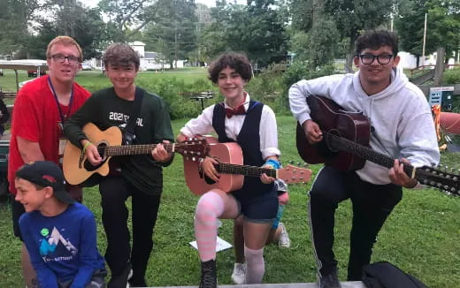 a group of people holding guitars