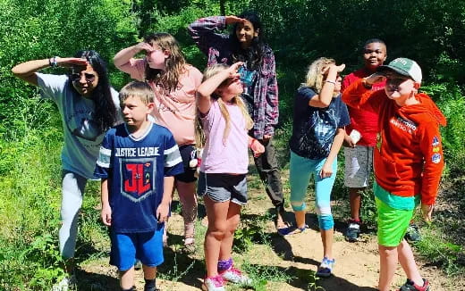 a group of people standing in a field