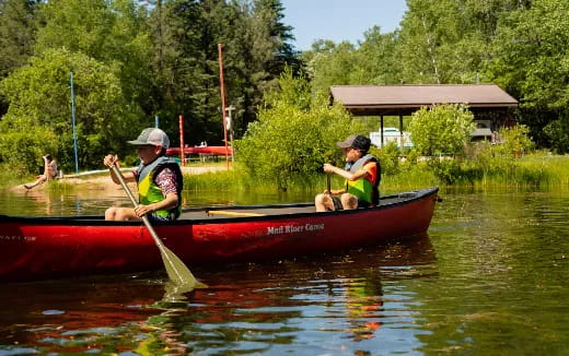 a couple of men in a canoe