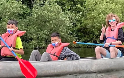 a group of people in a canoe