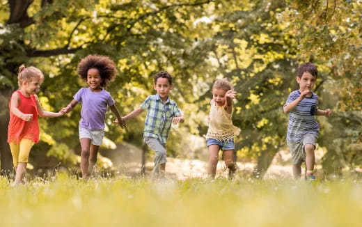 a group of children running in a field