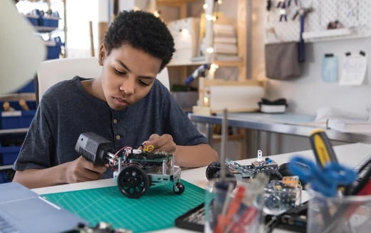 a young boy playing with a toy car