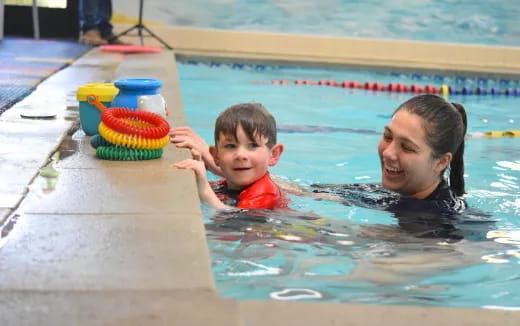 a person and a boy in a pool