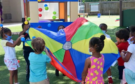 a group of children playing with a large tent