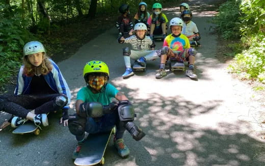 a group of kids wearing helmets and roller skates