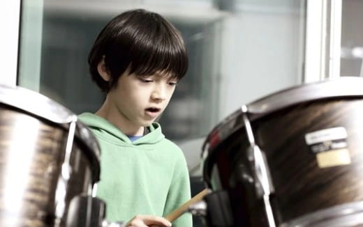a boy holding a steering wheel