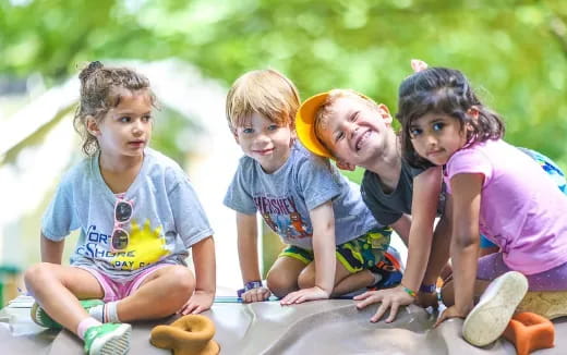 a group of kids sitting on the ground