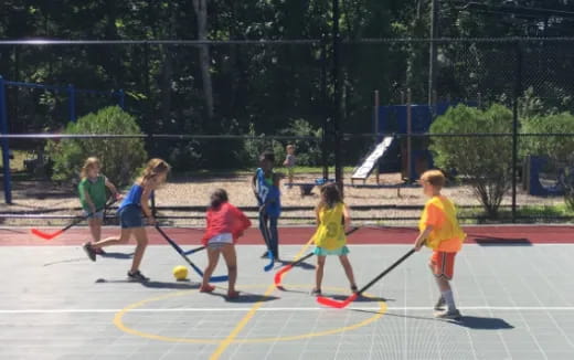 a group of kids playing hockey