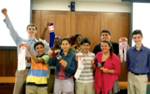 a group of people holding objects