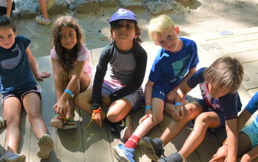 a group of children sitting on the ground