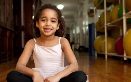 a young girl sitting on the floor