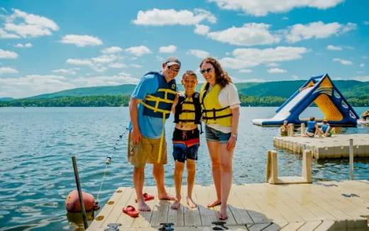 a group of people posing for a photo on a dock