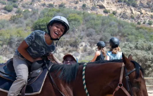a group of people riding horses