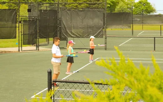 kids playing tennis on a court
