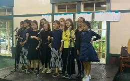 a group of girls in matching blue dresses
