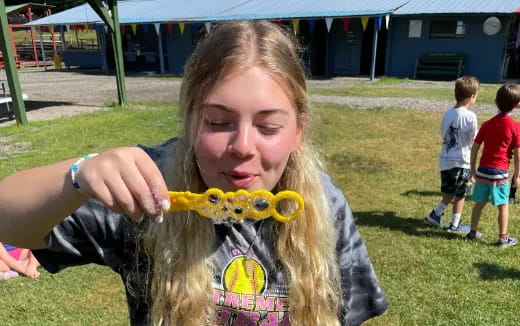 a girl holding a yellow toy
