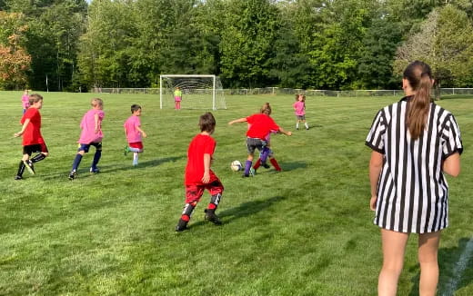 a group of kids playing football