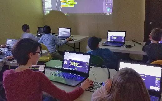 a group of people using laptops