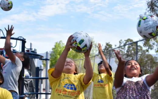 a group of people holding balls