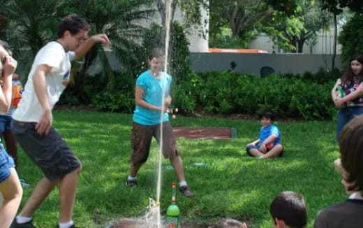 a group of people playing with sticks