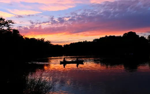 a couple of people rowing a boat
