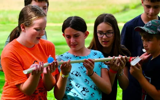 a group of kids holding a rope