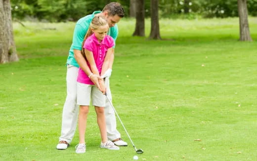 a man and a woman playing golf