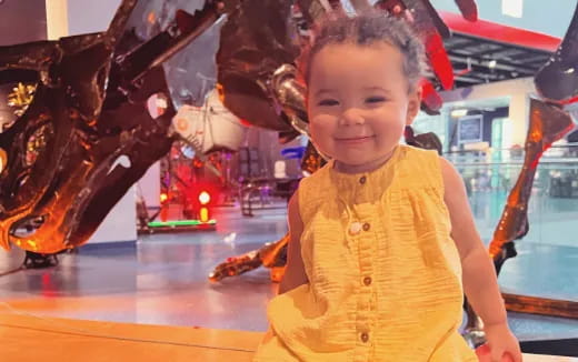 a child standing in front of a display of toys
