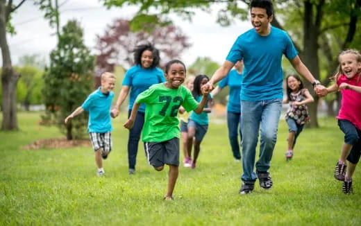 a group of people running in a park