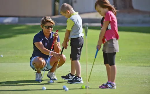 a group of kids playing golf