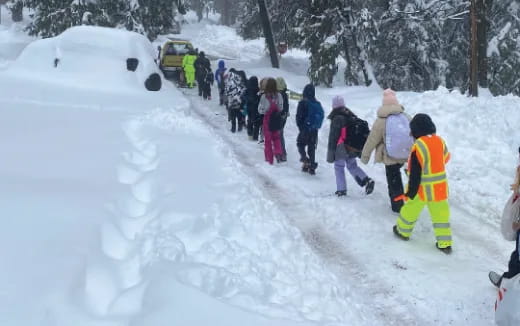 a group of people walking in the snow