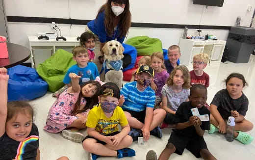 a group of people posing for a photo with a dog