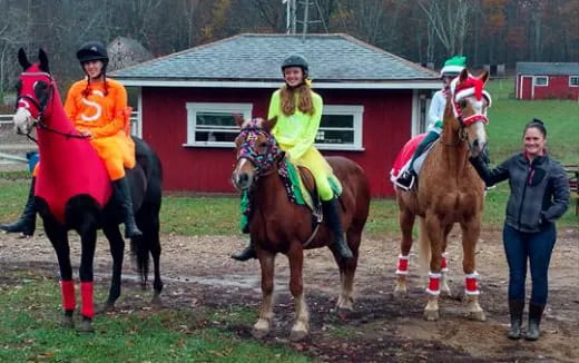 a group of people riding horses