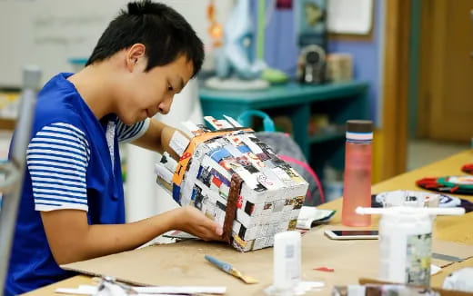 a young boy looking at a bag