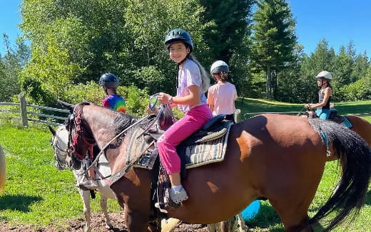 a group of people riding horses