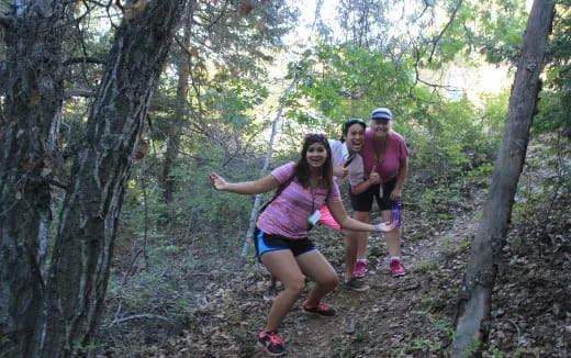 a group of people posing in the woods